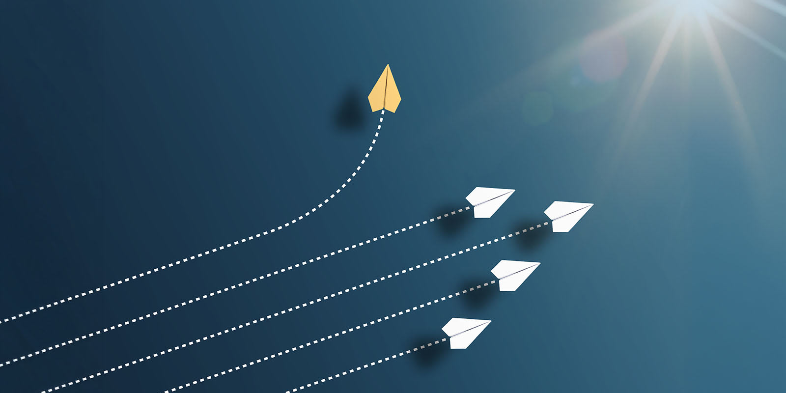Four paper airplanes going in one direction, with one changing direction.