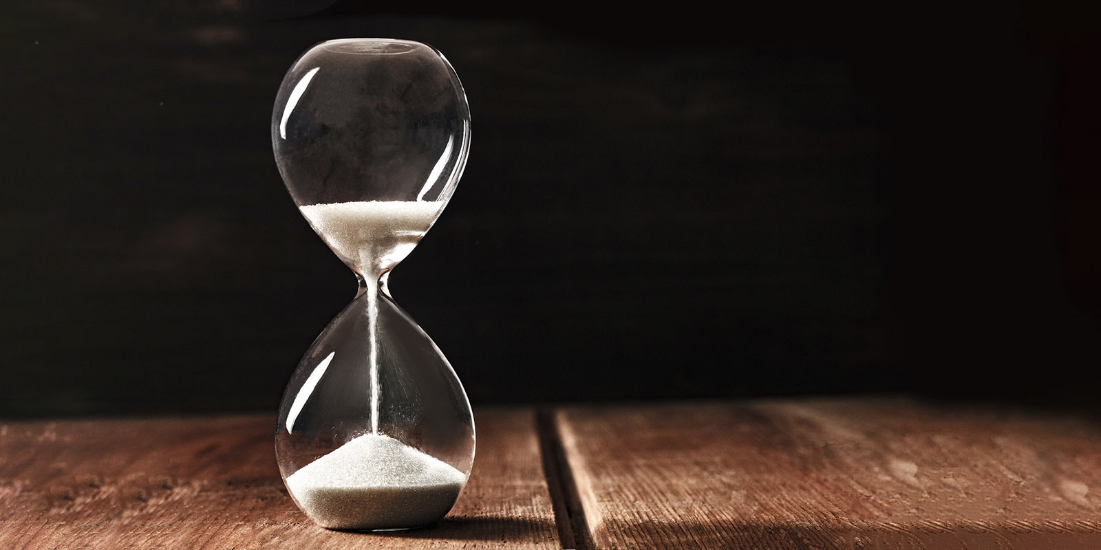 An hourglass set against a dark background.